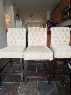 3 tan barstools