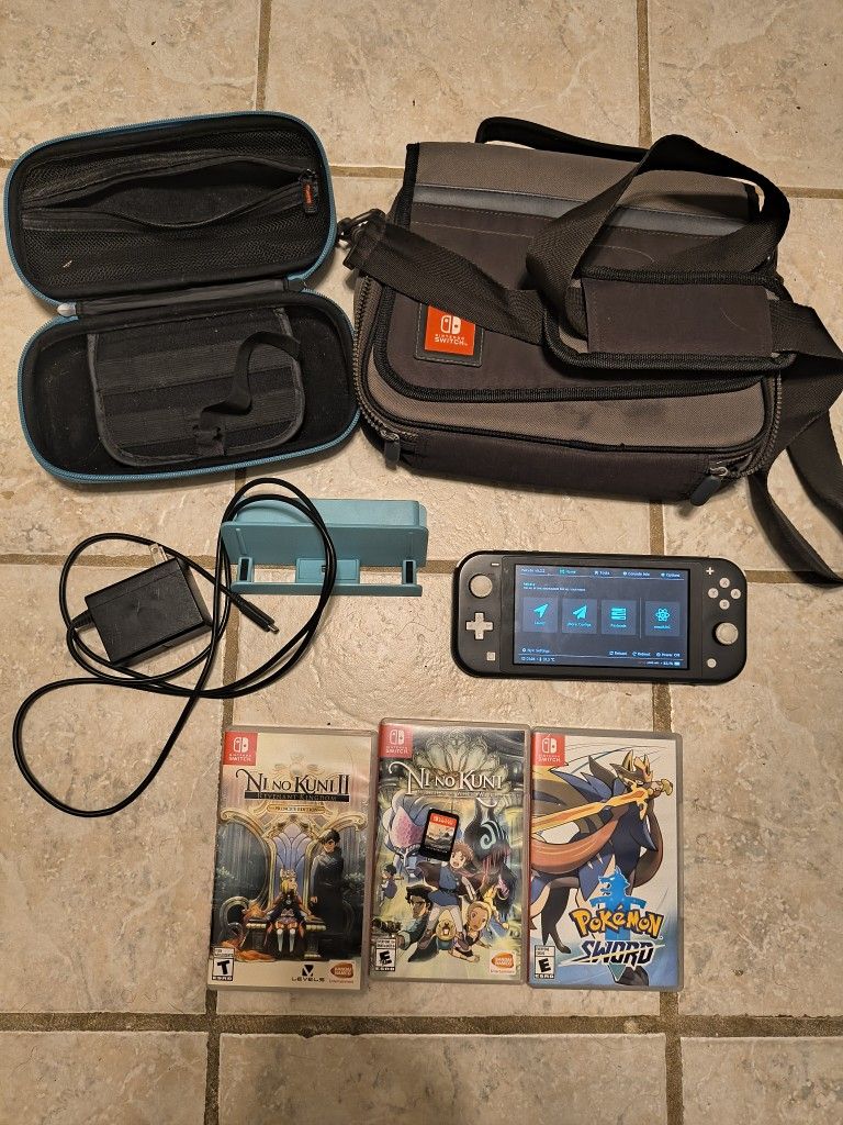Modchipped Switch Lite with accessories, games, and charger