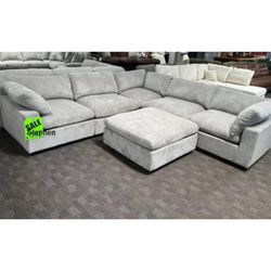 Light gray corduroy modular sectional sofa with ottoman