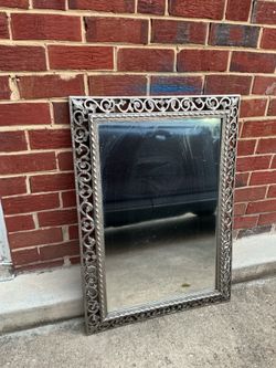 A beautiful , grey mirror with design around (36” x 26”)