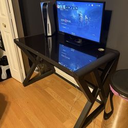 PlayStation 5 with desk, controller, and monitor