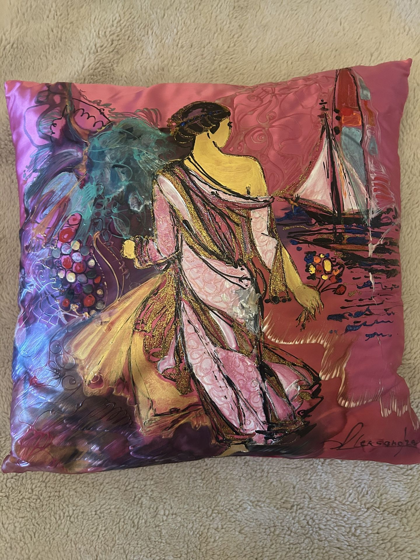 decorative pillow depicting a woman & a sailboat