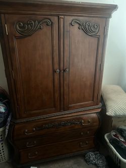 large, ornate wooden armoire/wardrobe with drawers
