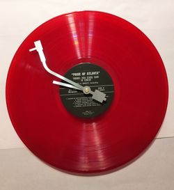 This is a very nice bright Red recycled 12" Vynal record converted into a beautiful wall clock with record tone arm clock hands.