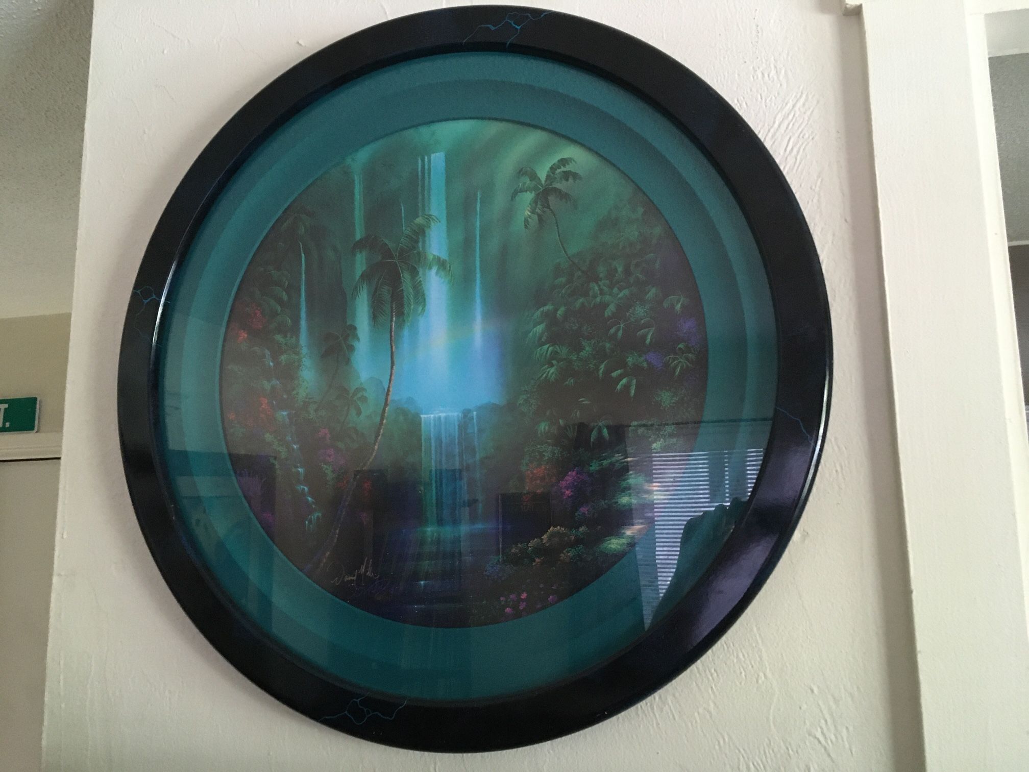 A David Miller tropical splendor print in round frame measures 29