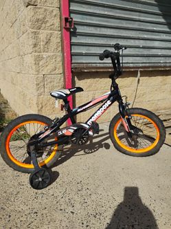 Mongoose Mutant Kids BMX-Style Bike with 16-inch orange rims and black frame. Ready to ride with training wheels