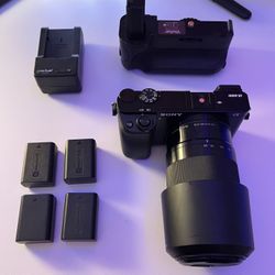 Sony a6000 Mirrorless Camera with Sony 55-210mm f4.5-6.3 E OSS Lens also with Battery Grip