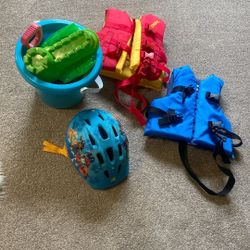 Two swimming vests , sandbox toys, paw patrol helmet