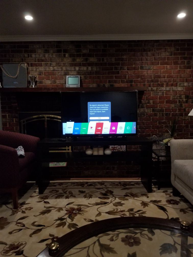 43 inch LG TV with the remote and a stand.