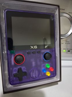 X6 Handheld retro video game console in transparent purple.  New.   fully laminated IPS OCA screen.  Features a dual 3D rocker design 4- core 32 bit p