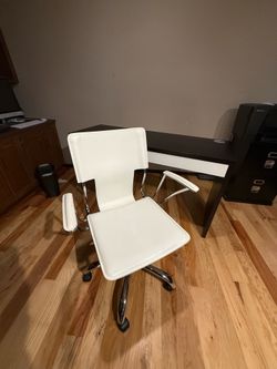 Leather office chair with arms.