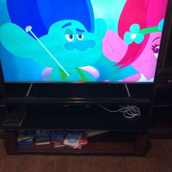 Entertainment Center. Nice glass/wood tv stand with two wood side furniture. $250 for all 3. TV not included.