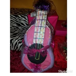 A baby girl guitar diaper cake