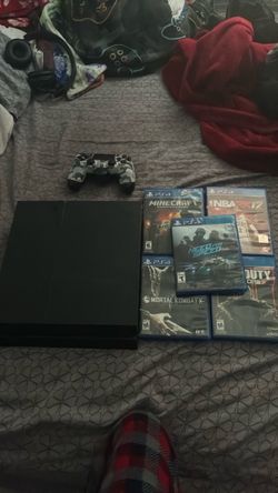 PS4 with controller and games