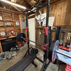 Bench press + squat rack with bar and weight