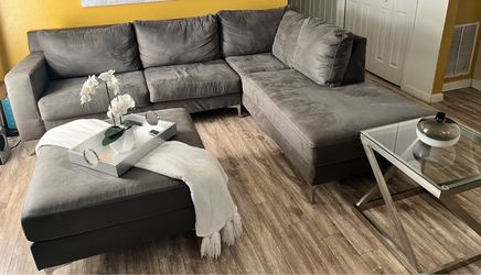 Ashley Furniture Gray sectional sofa with ottoman and end table