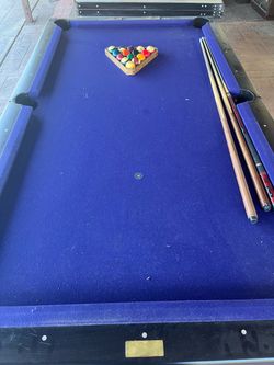 Pool Table with Balls and Cue Sticks