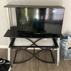 2 TVs, A Stand, Table With 4 Chairs, And Ac Unit 