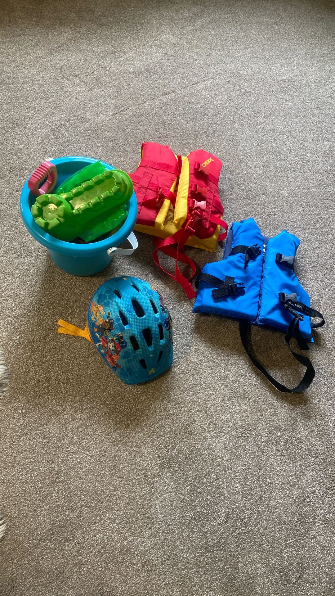 Two swimming vests , sandbox toys, paw patrol helmet