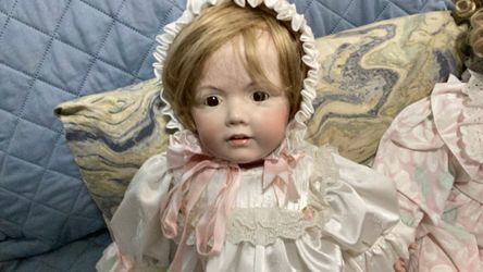 Porcelain face, feet and hands. Blonde baby girl has two front teeth