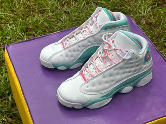 Air Jordan 13 Retro "Aurora Green" sneakers, featuring a white leather upper with vibrant green and pink detailing.