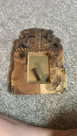carved wood hanging mirror