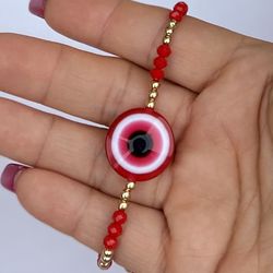 red bracelet with criatal stones and lucky eye