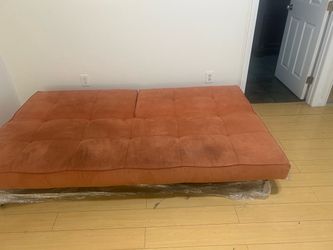 Pink velvety sofa bed
