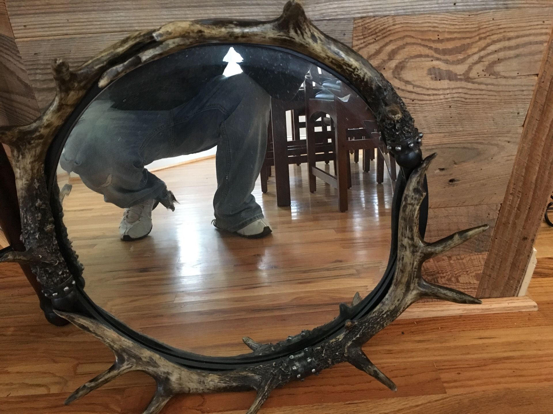 Mirror with a set of deer horns arranged around them