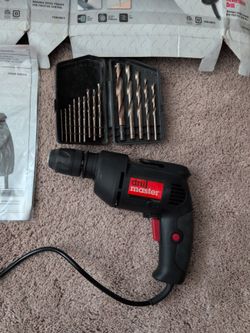 Drill master 3/8" variable speed reversible drill and drill bits.
