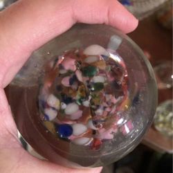 Vintage clear glass paperweight with colorful glass inside