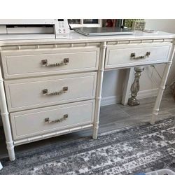 Faux bamboo Hollywood Regency style beige vintage desk. In good overall condition with some scrapes towards the back of the top of the desk
