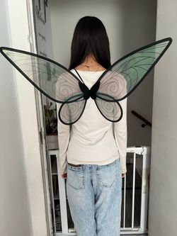 Iridescent wings. Green wings. Tinker Bell.