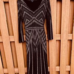Gorgeous! Black and rose gold or gold depending on the lighting. Floor length dress, long sleeves-Size 18.