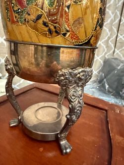 Egg on a silver-plated stand. China. Height 10 inches, diameter 6 inches.