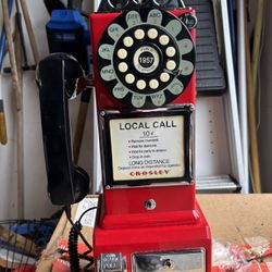 Vintage-style Crosley payphone, red color.