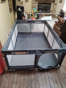 Extra large playpen for children with an opening in the front that zips up.
