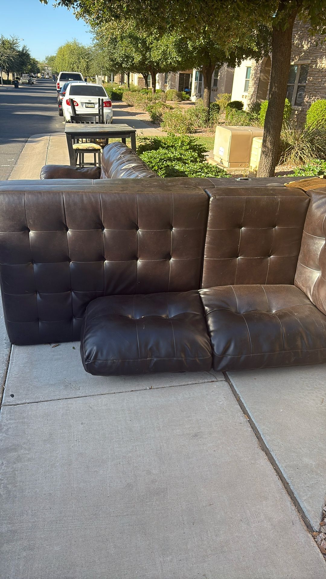 Leather Couch And Table With Three Chairs