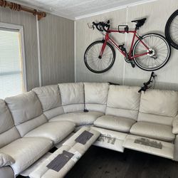 Natuzzi editions Leather sectional sofa with 4 manual recliners. Good condition (recliners still have protected plastic fold on it),except a 2.5” cut 