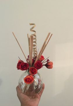 Glass vase with fake roses table decor