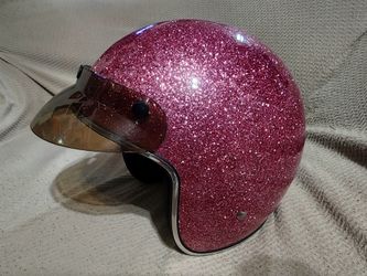 Pink metal flake motorcycle helmet.