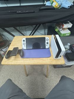 Nintendo switch OLED with joy con + 5 games and two additional controllers, docking station, and a protective carrying case