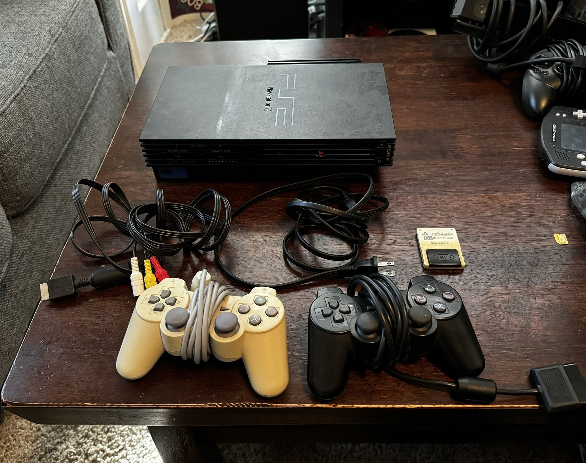 PlayStation 2 W/ 2 Controllers & 1 Memory Card & Online Compatibility Module.