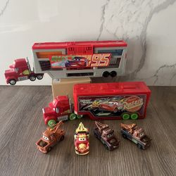 Disney and Pixar Cars toys, primarily featuring Mack haulers and Mater vehicles.