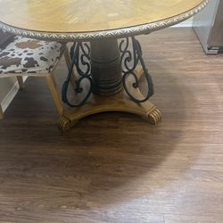 Round Dining table, 50” Magnavox TV, Large black area rug, red decorative runner and a black office chair