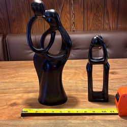 $20  (2) man and woman statues