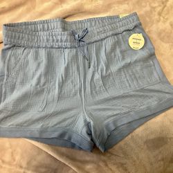 Comfortable women's relaxed shorts with an elastic drawstring waist. Lightweight textured fabric for soft hem for easy movement. Light blue color adds