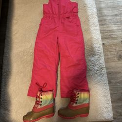 Pink snow pants and boots.