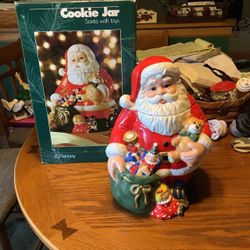 vintage JC Penney Home Collection 12-inch Santa Claus with Toys Cookie Jar featuring Santa holding a teddy bear and a green toy bag.Product OverviewIt