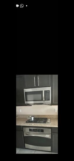 GE stainless steel oven with convection bake, convection roast, broil, and self-clean features.